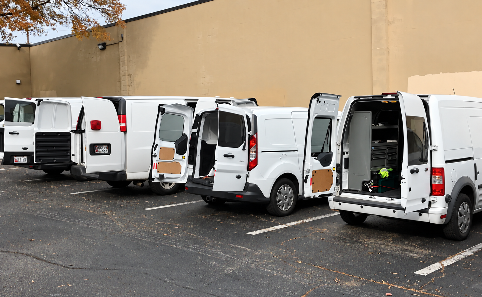 Fleet of white Mr. Locksmith service vans in a parking lot
